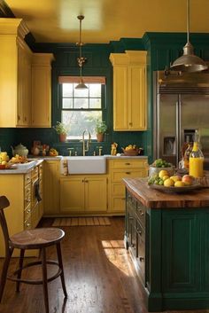 a kitchen filled with lots of yellow and green cupboards next to a wooden floor