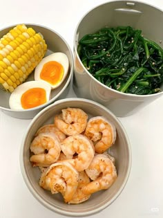 two bowls filled with shrimp, corn and green beans next to an egg on the cob