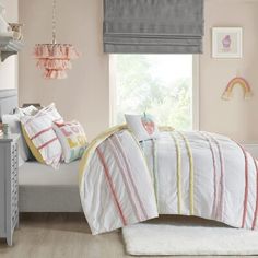 a child's bedroom with pink walls, white bedding and grey dressers