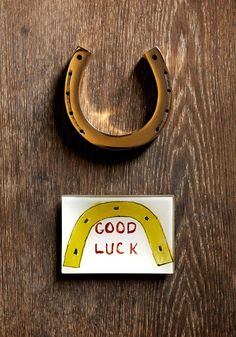 a wooden table topped with a horseshoe and magnet