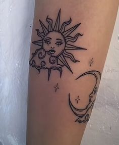 a sun and moon tattoo on the leg