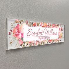 a sign on the wall that says scrawlt williams hospital nurse and has flowers painted on it