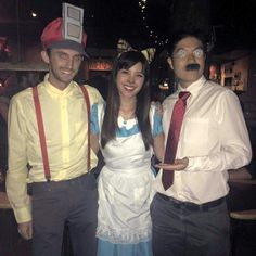 three people dressed in costumes posing for a photo