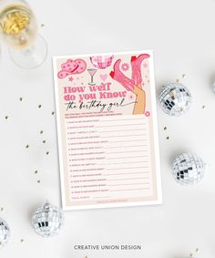 a pink and gold bachelor party game on a white table with disco balls around it