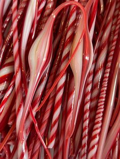 red and white candy canes are stacked together