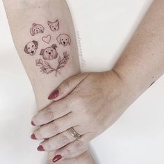 two hands holding each other with tattoos on their arm and wrist, both showing the same animal faces