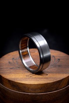 two rings sitting on top of a wooden box