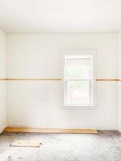 an empty room with white walls and no one in the room or there is a window