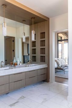 a large bathroom with two sinks and mirrors