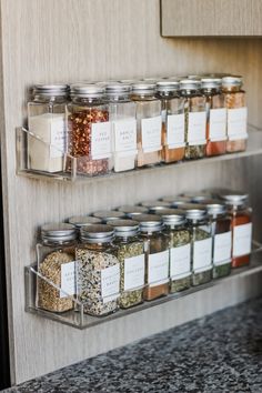 spices and seasonings are stored in glass containers on the wall