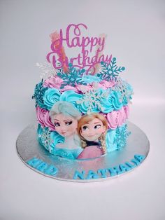 a birthday cake with two frozen princesses on it's top and the words happy birthday written in frosting