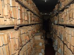 many stacks of wooden boxes in a warehouse