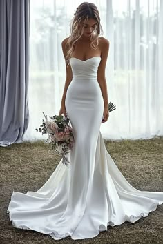 a woman in a white wedding dress holding a bouquet