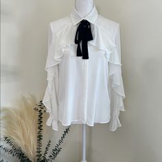 Zara White Ruffled Blouse Flowing Collared Shirt With Long Sleeves, Elastic Cuffs, And Ruffle Trim On The Front. Fastening With A Contrast Tied Bow And Button Up Fastening Hidden By A Placket. Siz: Small Material: 100% Polyester Condition: Nwt Elegant Workwear Shirt With Ruffled Collar, Classic Ruffled Shirt For Office, Feminine Ruffled Office Shirt, White Ruffled Blouse For Office, Office Shirt With Ruffled Collar And Details, Collared Ruffle Blouse For Workwear, Tie Neck Ruffled Blouse For Workwear, Ruffled Tie Neck Blouse For Work, Elegant Zara Shirt For Formal Occasions