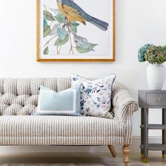 a living room with a couch, table and painting on the wall