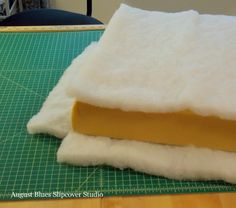 two pieces of felt sitting on top of a cutting board