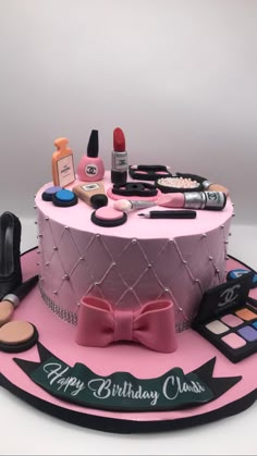 a birthday cake decorated with makeup and cosmetics