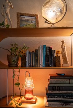 a lamp on a shelf next to some books