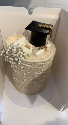 a cake in the shape of a graduation hat with flowers