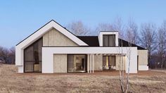 a white house sitting on top of a dry grass field