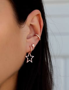 a close up of a person's ear with two stars attached to the ear