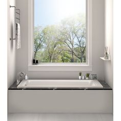 a white bath tub sitting under a window