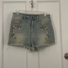 Embroidered Shorts With A Raw Hem. Never Worn. High Waist Denim Blue Bottoms With Floral Embroidery, High-waist Denim Blue Bottoms With Floral Embroidery, Embroidered High Rise Blue Bottoms, Trendy Floral Embroidered Denim Blue Bottoms, Trendy Denim Blue Bottoms With Floral Embroidery, Trendy Embroidered Mid-rise Bottoms, Casual Denim Bottoms With Floral Embroidery, High Rise Floral Embroidered Bottoms For Spring, Casual Embroidered Mid-rise Bottoms