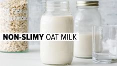 there is a bottle of milk next to two glass jars with oats in them