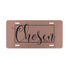 a pink license plate with the word chosen in cursive scripting on it