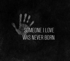 someone i love was never born on black and white background with hand in the dark