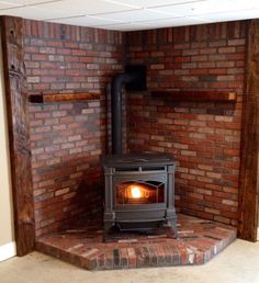 a wood burning stove sitting inside of a brick wall