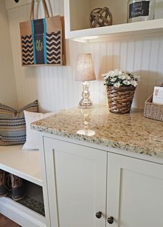 a kitchen counter with baskets and flowers on it