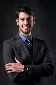 a man in a suit and tie with his arms crossed