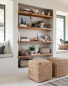 a living room filled with lots of shelves covered in wicker baskets and vases