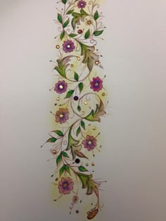 an artistically designed wall hanging with flowers and leaves on the side, painted in white