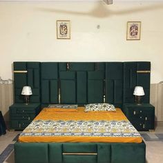 a bed with green headboard and two lamps on either side, in a bedroom