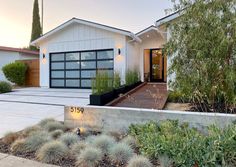 a modern home with landscaping in the front yard