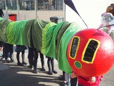 a group of people in costumes standing next to each other on the street with children