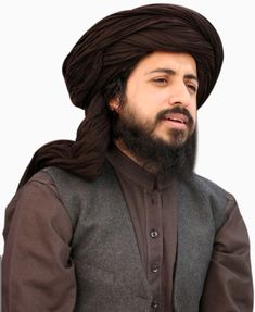 a man with a beard wearing a brown turban