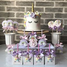 a birthday cake and cupcakes with unicorn decorations