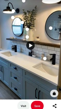 a bathroom with two sinks, mirrors and lights on the wall next to each other