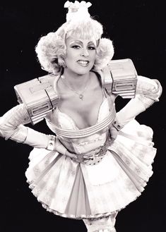 a woman dressed in a costume and holding two boxes