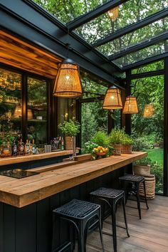 an outdoor bar with stools and lights