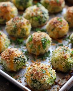 some broccoli and cheese balls are on a baking sheet, ready to be eaten