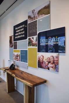 a wooden bench sitting in front of a wall covered with pictures and words on it