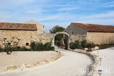 an old stone building with a walkway leading to it