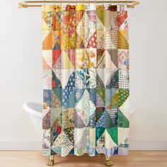 the shower curtain is made up of colorful patchwork quilts and floral designs on it