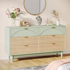 a bedroom with a dresser, mirror and flowers on the sideboard in front of it