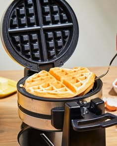 a waffle maker is being used to make some type of breakfast food on the table