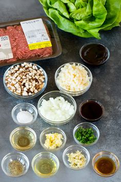 an assortment of ingredients are shown in bowls on a counter top next to lettuce